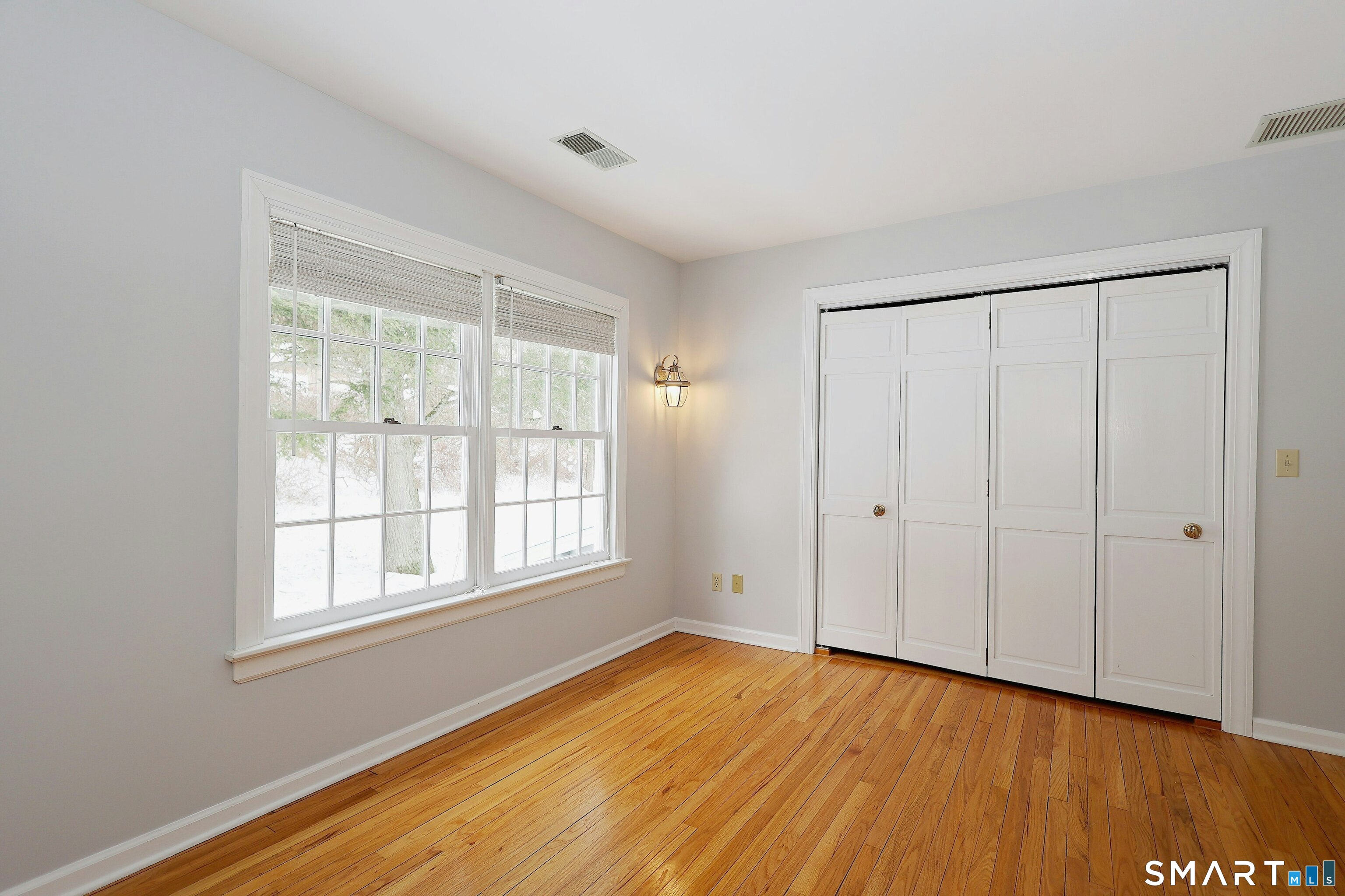 36-40 Fox Run Road Redding, CT 06896 - Photo 29 of 40 a view of an empty room with wooden floor and a window