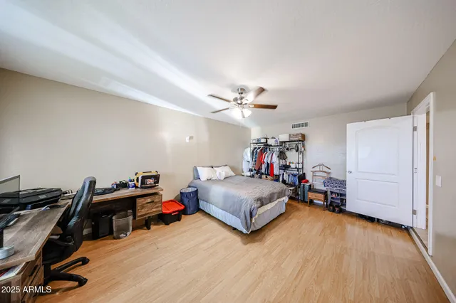 a bedroom with furniture and a wooden floor