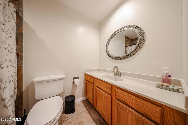 a bathroom with a toilet a sink and a mirror