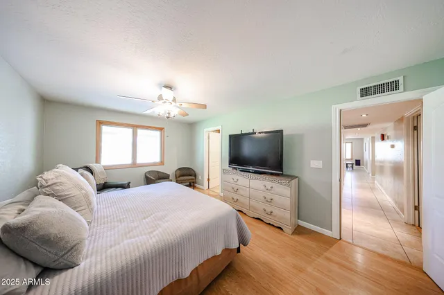 a bedroom with a bed and a flat screen tv