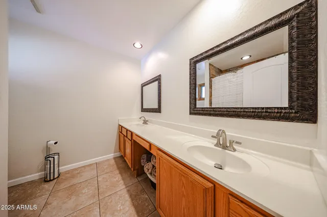 a bathroom with a double vanity sink mirror and