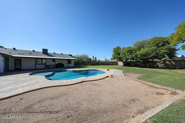 a view of a swimming pool with a yard