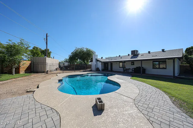 a swimming pool with outdoor seating yard and barbeque oven