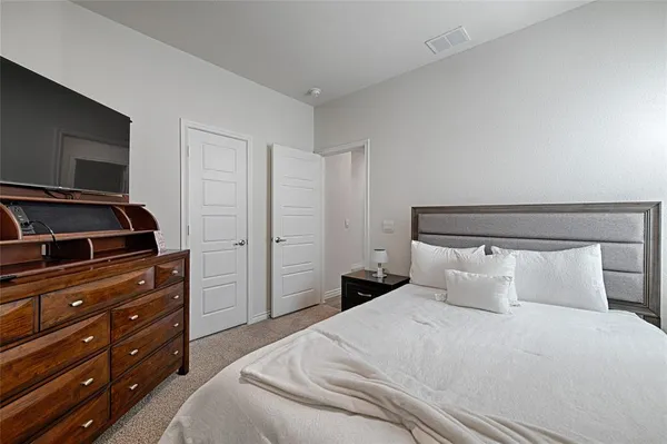 a bedroom with a bed and a dresser