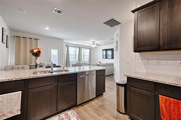 a kitchen with a sink stainless steel appliances and cabinets