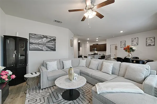 a living room with furniture and a chandelier