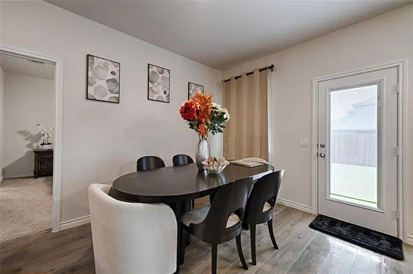 a dining room with furniture and window