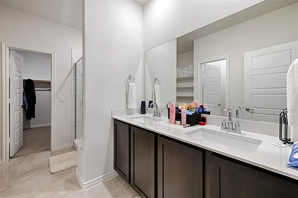 a bathroom with a sink double vanity and a mirror