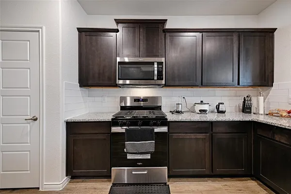 a kitchen with a sink and a stove top oven