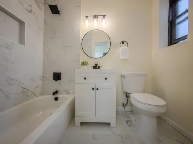 a bathroom with a sink a toilet and a bathtub
