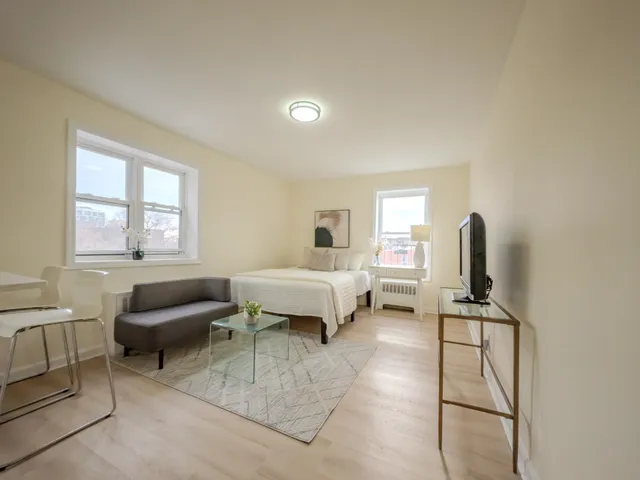 a bedroom with furniture and a window