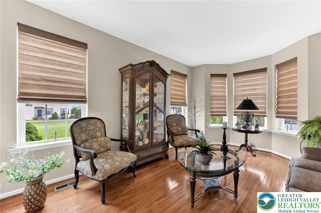5440 Spring Ridge Drive West Macungie, PA 18062 - Photo 5 of 40 Hardwood floors complement this inviting living room with ample natural light from multiple windows.