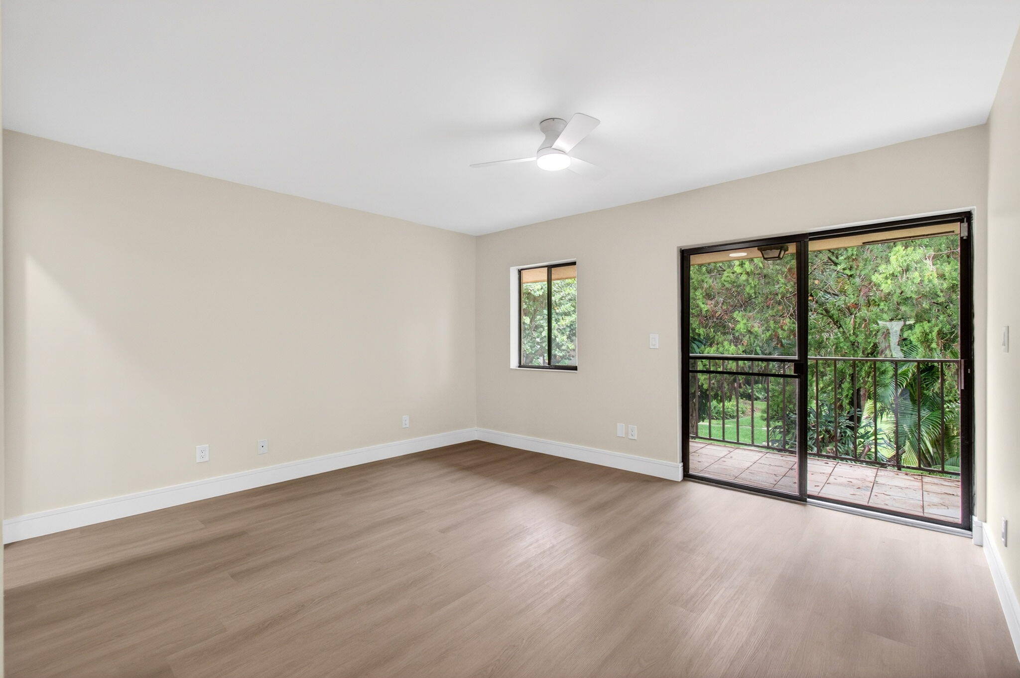 1330 Northwest 13th Street, Unit 12 Boca Raton, FL 33486 - Photo 22 of 52 a view of a big room with wooden floor and windows