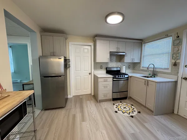 a kitchen with a refrigerator a stove top oven a sink and dishwasher