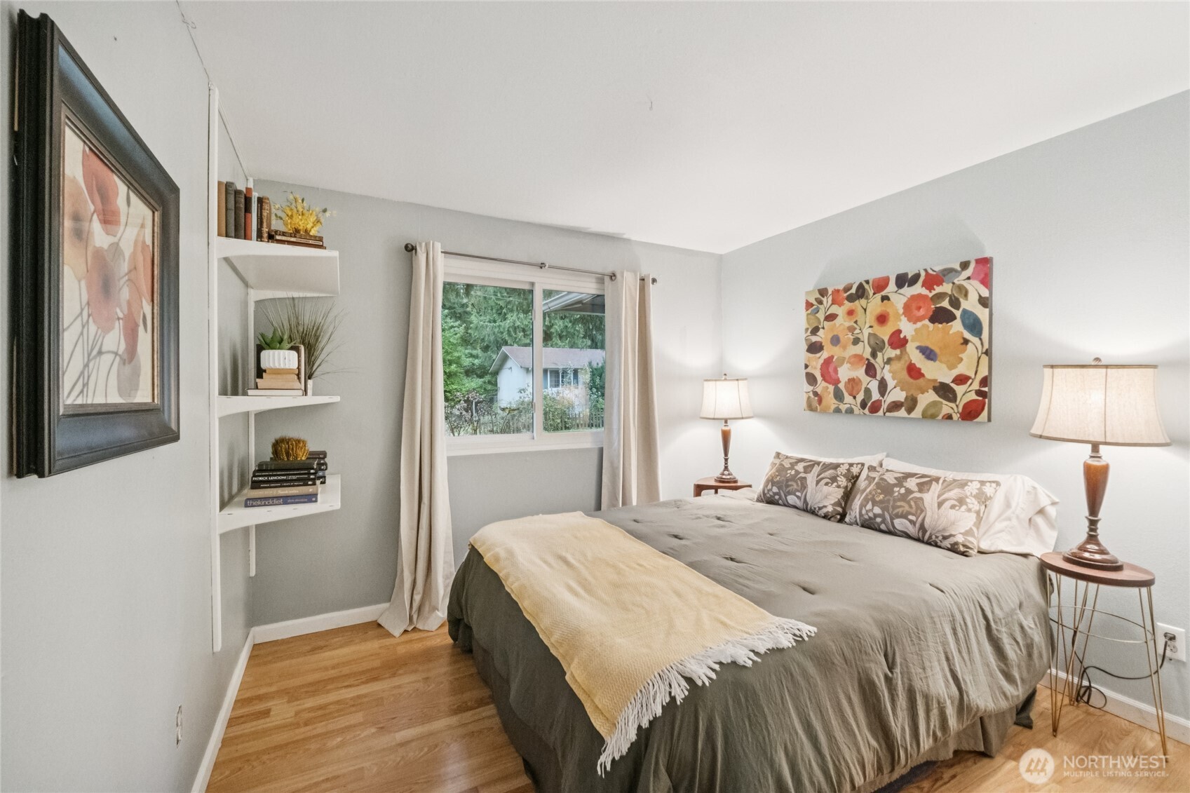 20911 West Richmond Road Bothell, WA 98021 - Photo 17 of 25 a bedroom with a bed and a painting on the wall