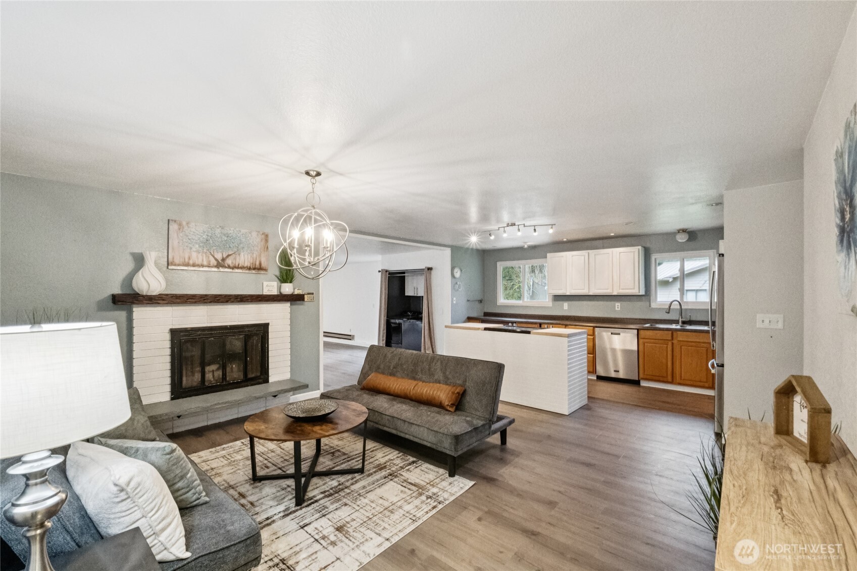 20911 West Richmond Road Bothell, WA 98021 - Photo 6 of 25 a living room with furniture and a fireplace