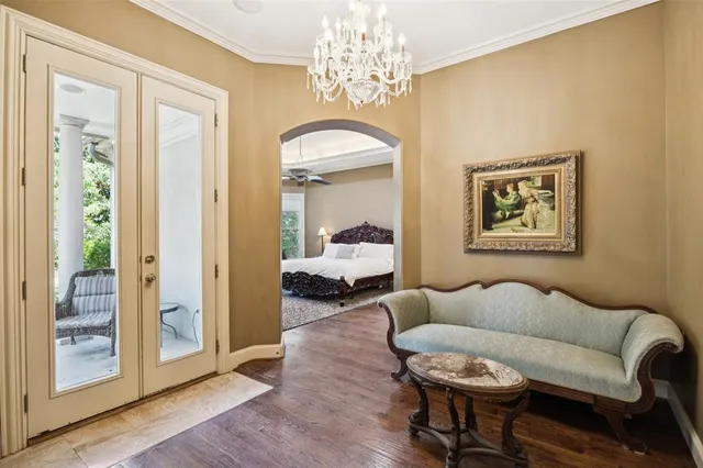 a living room with furniture and a chandelier