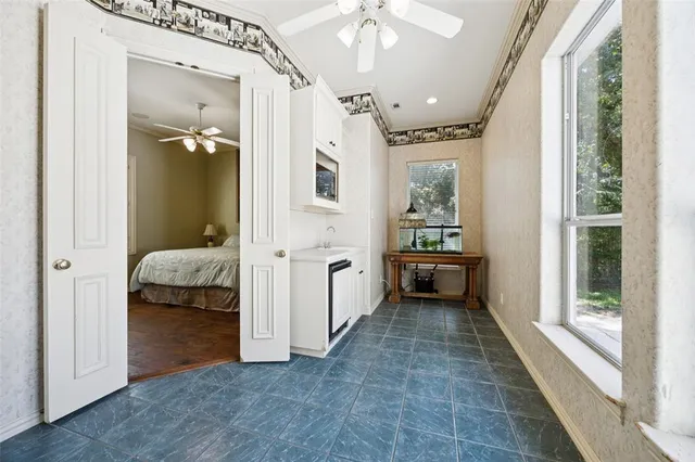 a view of a hallway with a livingroom and a bedroom