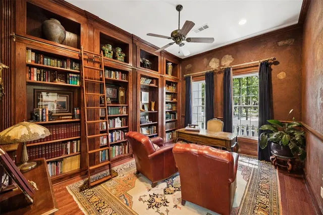 a living room with furniture and a book shelf