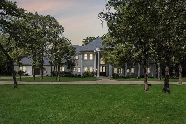 a front view of a building with a garden