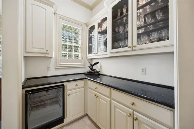 a kitchen with granite countertop white cabinets and a stove