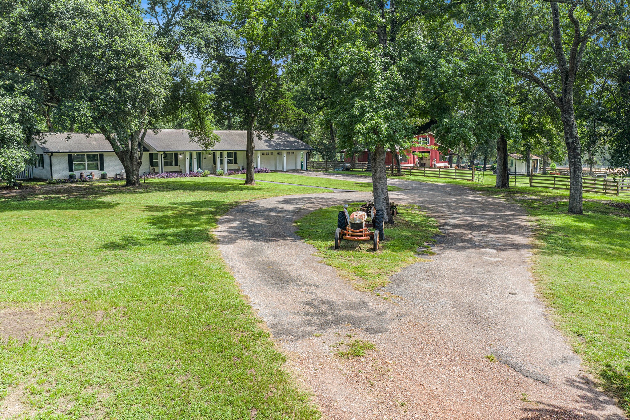 7363 County Line Road Willis, TX 77378 - Photo 2 of 34 Charming circular driveway framed by mature trees enhances the home's inviting appeal.