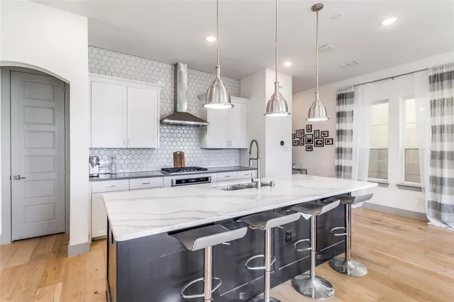 a kitchen with a stove a sink and a refrigerator