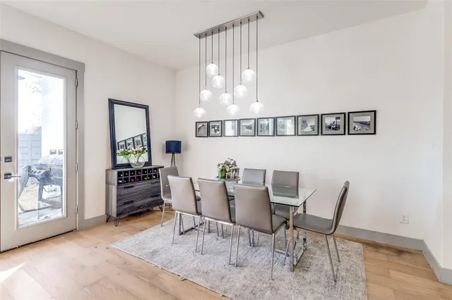 a kitchen that has a lot of cabinets in it and wooden floors