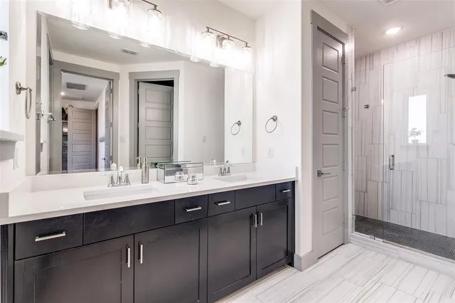 a spacious bedroom with a bed and a chandelier