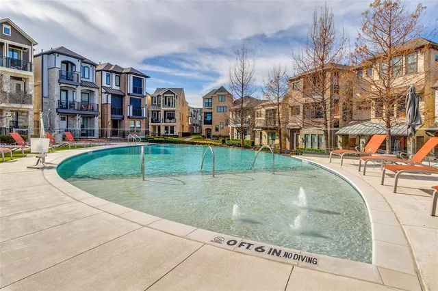 an outdoor space with pool and seating