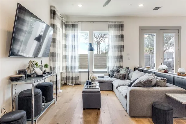 a living room with furniture and a floor to ceiling window