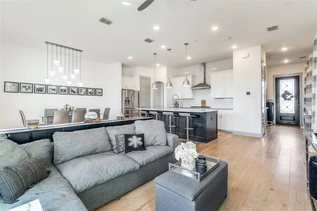 a living room with furniture and kitchen view