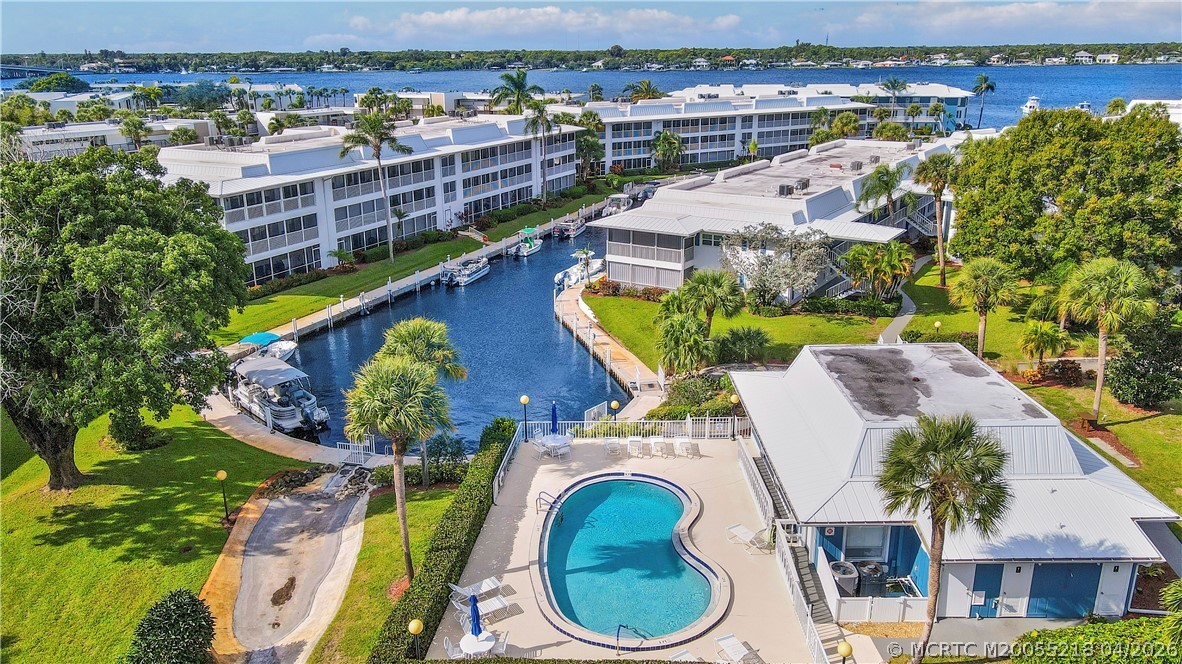 1854 Southwest Palm City Road, Unit 203 Stuart, FL 34994 - Photo 33 of 38 Enjoy true Florida living with three heated pools this pool is at the Clubhouse), waterfront lounging areas, and boat docks just steps away—perfect for boating, relaxing, and soaking in the coastal lifestyle