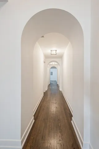 a view of a room with wooden floor and fireplace