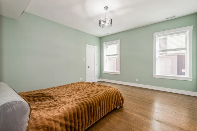 a kitchen with stainless steel appliances a stove a sink and white cabinets