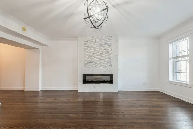 a kitchen with stainless steel appliances granite countertop a sink a stove a refrigerator and white cabinets