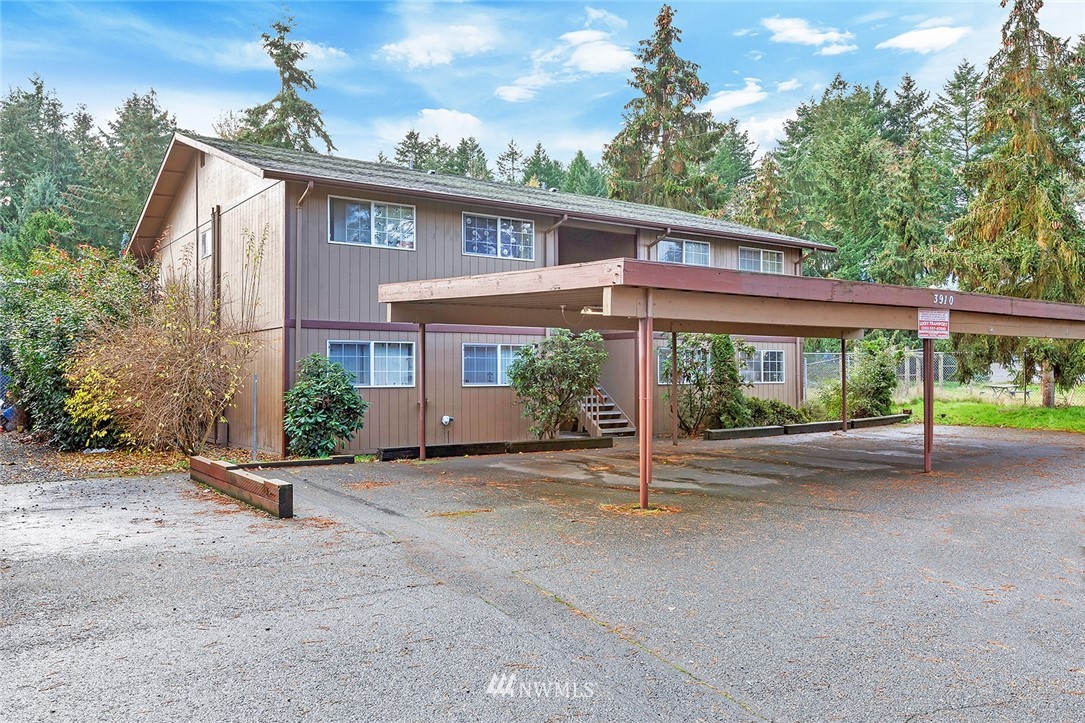 3910 Mason Loop Road Tacoma, WA 98409 - Photo 1 of 9 a view of a house with a yard and potted plants