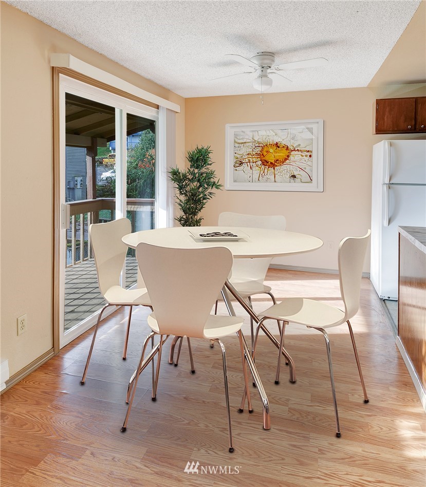 3910 Mason Loop Road Tacoma, WA 98409 - Photo 3 of 9 a view of a dining room with furniture a chandelier and wooden floor