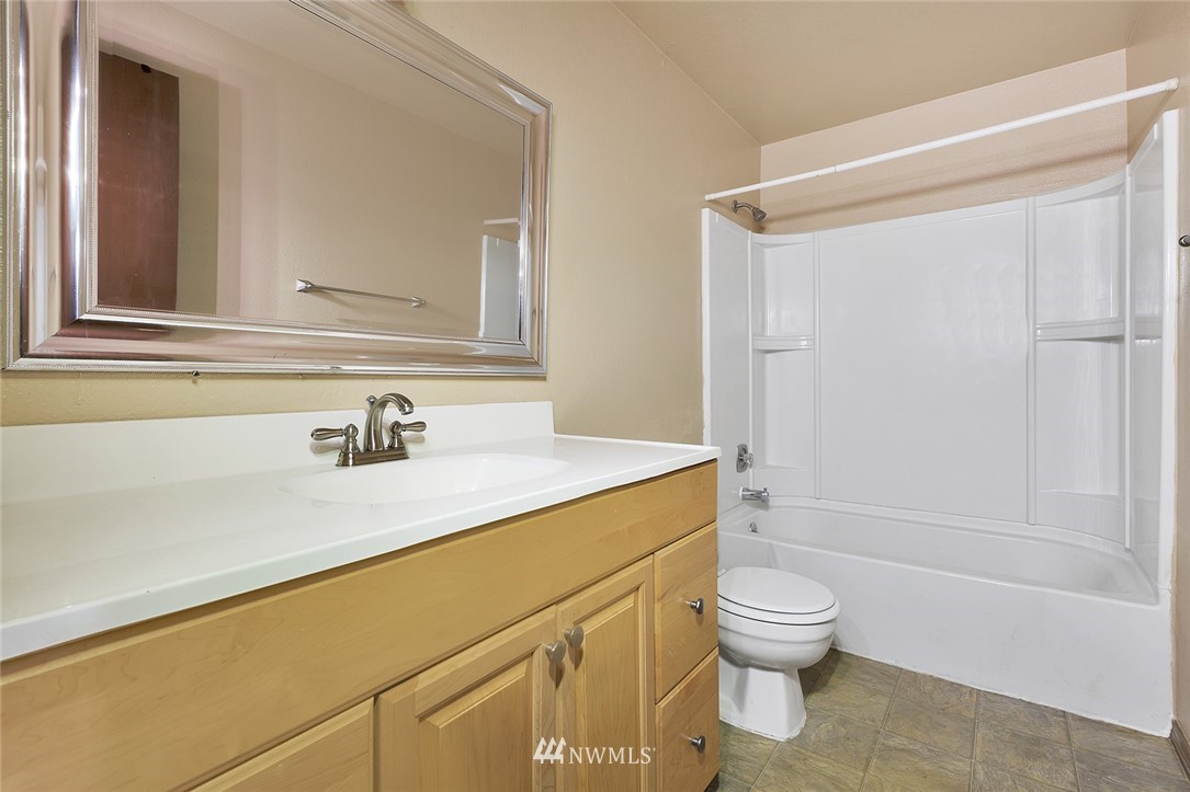 3910 Mason Loop Road Tacoma, WA 98409 - Photo 7 of 9 a bathroom with a sink a toilet and shower