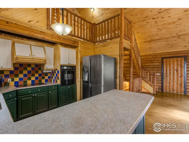 a kitchen with a sink and large window