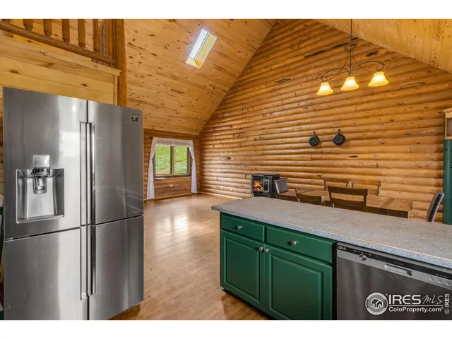 a bedroom with a bed a dresser next to a window