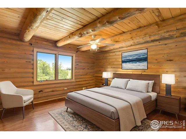 a bedroom with a bed a dresser next to a brick wall