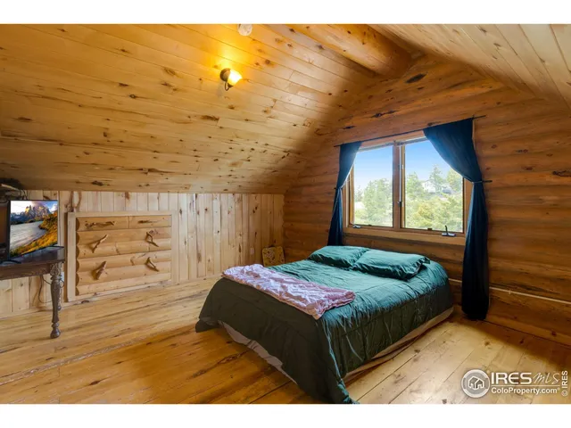 a bedroom with a bed and a night stand