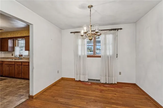 a view of an empty room with a kitchen