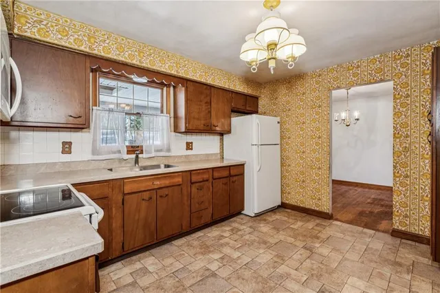 a kitchen with a sink appliances and cabinets