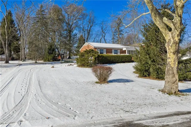 a view of a house with a snow in the yard