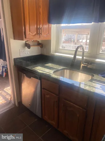 a kitchen with a sink a counter top space and cabinets