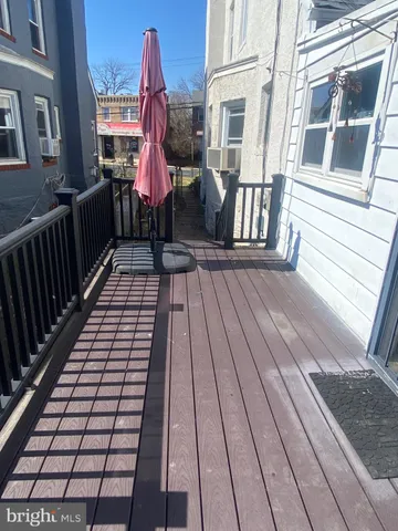 a view of a balcony with wooden floor