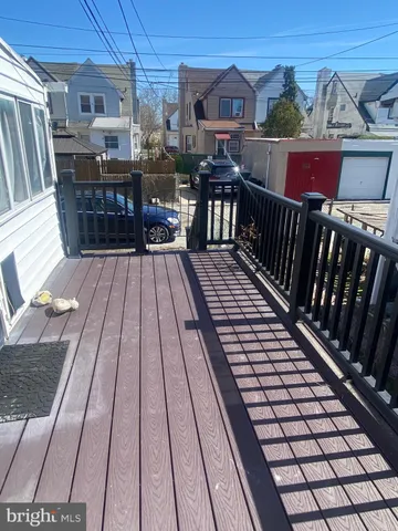 a view of a deck with wooden floor and barbeque oven