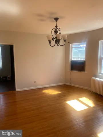 a view of a room with wooden floor and window